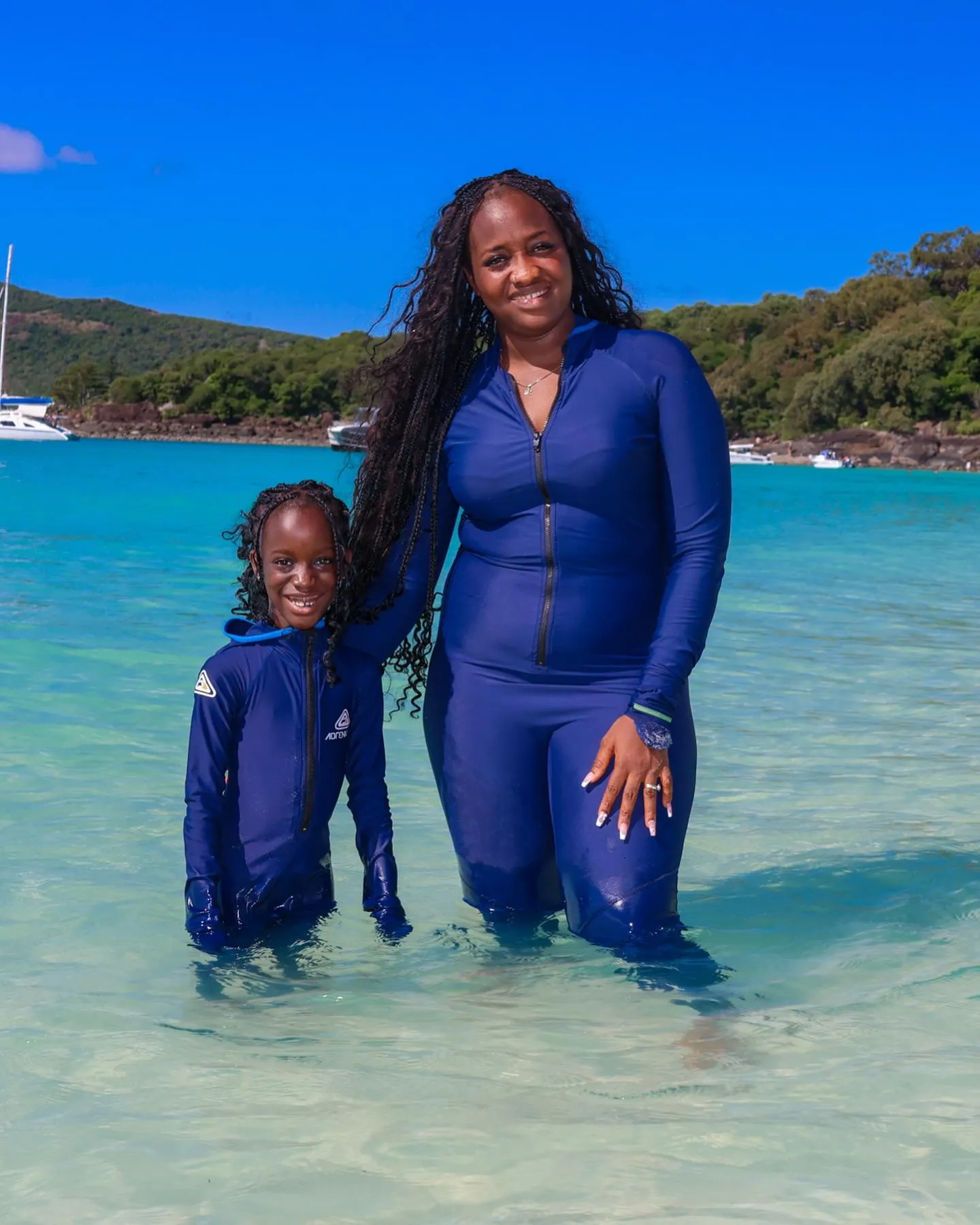 Mariama and her little one — braids are a family affair